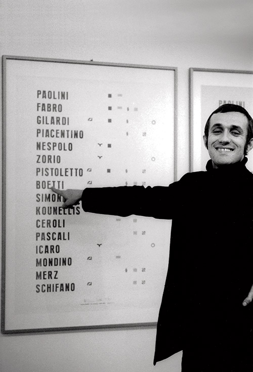 Alighiero Boetti in front of the Manifesto at the Franco Toselli gallery in Milan 1970, photo by Paolo Mussat Sartor