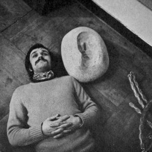 Alighiero Boetti near his self-portrait in negative, 1969